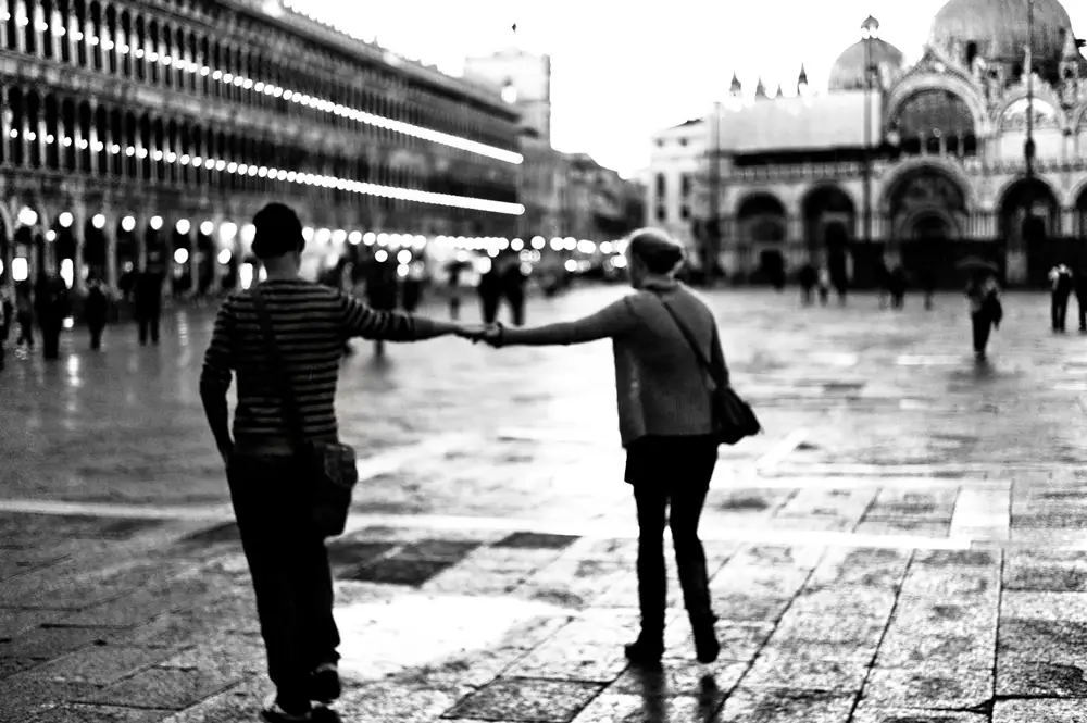 Couple of tourists in S. Marc square, Venice.