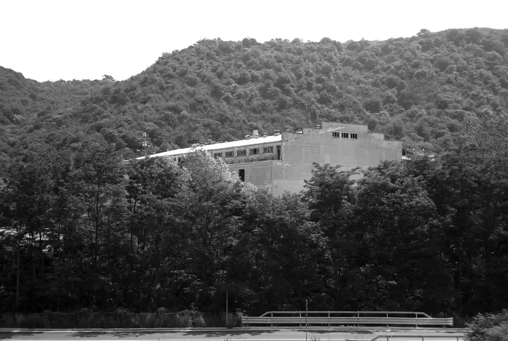 A view from the LRF of the former industrial coater building (“Big Boy”), now empty and partially demolished and idling behind the lush trees in the valley carved by the Fiume Bormida - FILM FERRANIA P30, June 2017