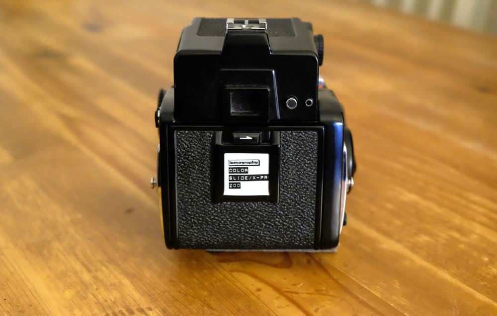 Mamiya 645 1000S - Loading film step 7 - Close the film door and slide in your film reminder…done!
