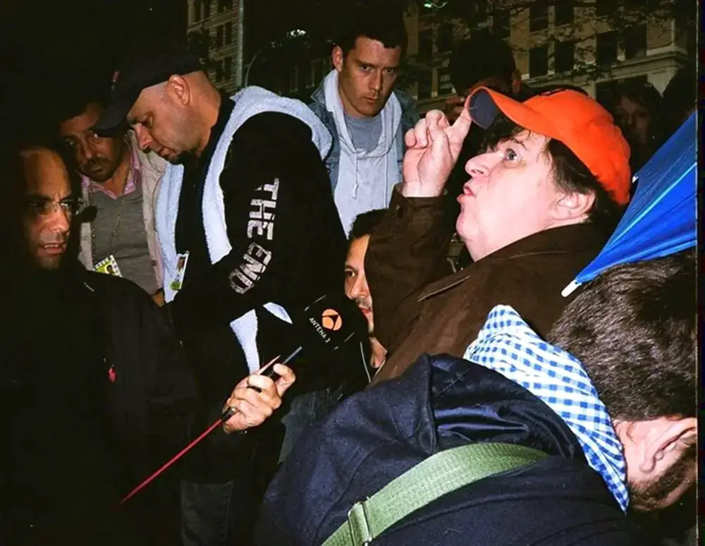 The Interview's Direction. Photographed with my Minolta Hi-Matic, & on Kodak's Gold, small-format, 135 film, 400 speed. This was during the Occupy Wall St. protesting in lower Manhattan. Filmmaker, Michael Moore was conducting an interview. I used the flash on my Minolta to photograph this frame.