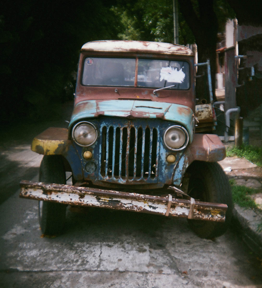 An old Jeep-imitation vehicle (known as an “Estanciera”) parked in a neighborhood street in Buenos Aires. Holga 135BC slightly cropped, Lomo 400 negative film.