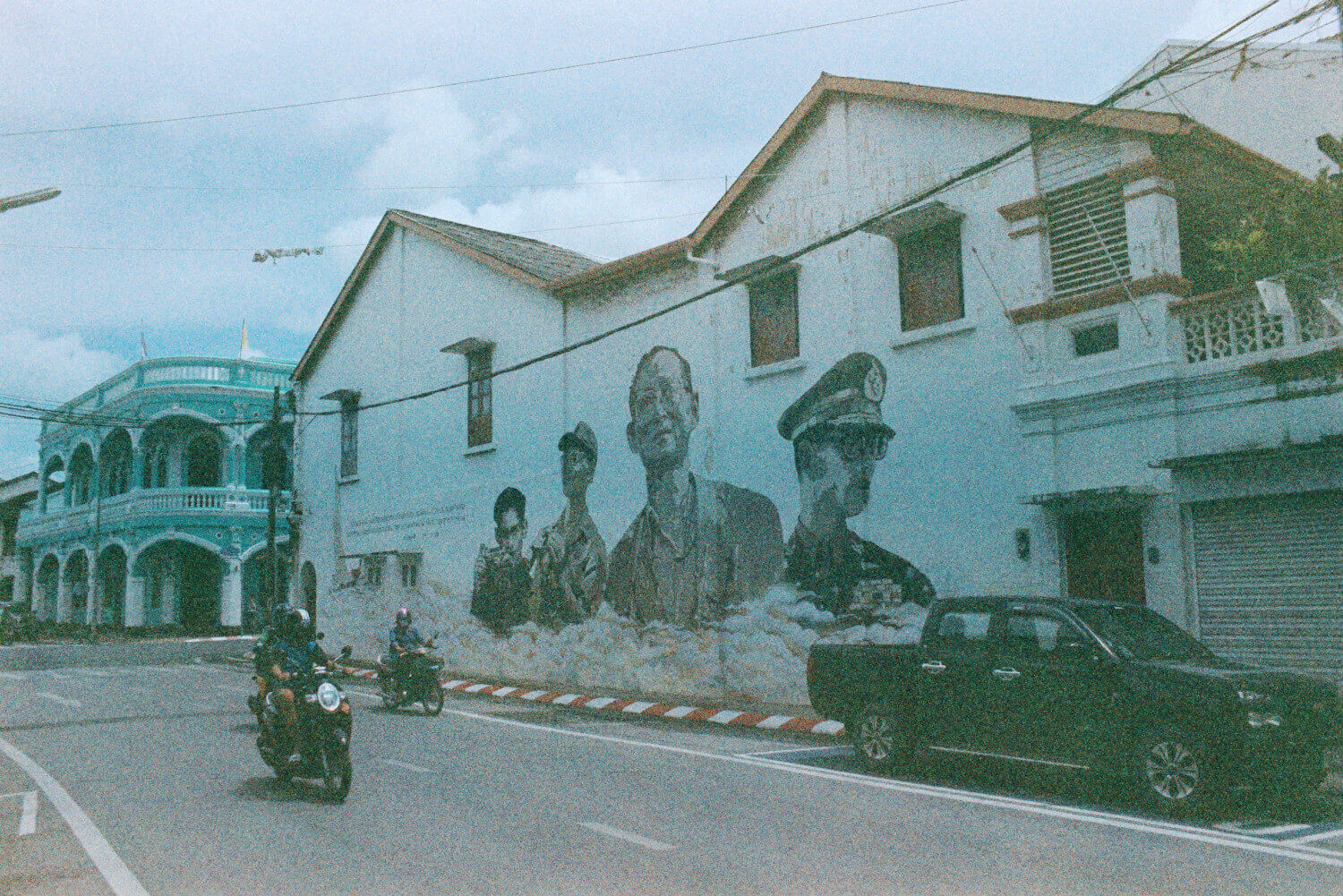 Street scene of the late King Bhumibol depicted in street art, Phuket, Thailand: 5 Frames... With a Canon A-1 and a roll of 1987 Sainsbury's Colour Print Film (CPF) and a Canon A1 - by James Patrick