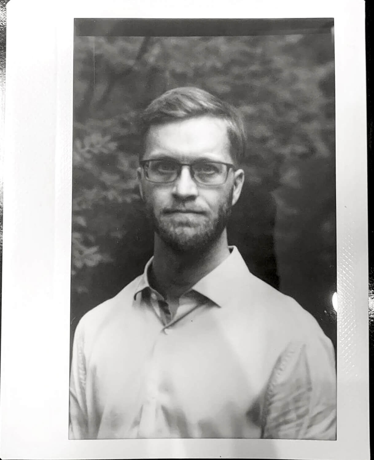 A portrait of my brother-in-law, on instax wide monochrome, exposed in a 4x5 holder using a 3d printed insert
