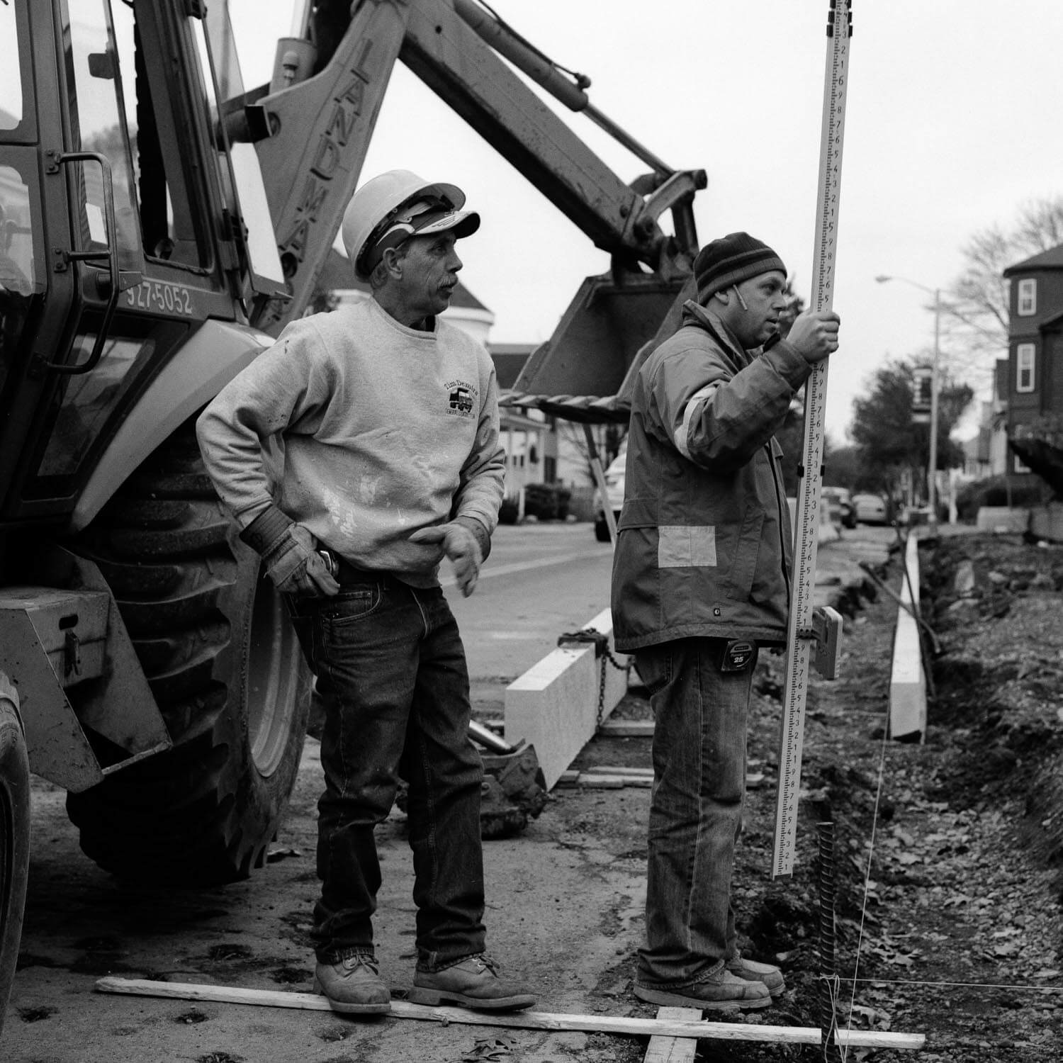 Guys putting down street curbs - This image seems to fit the square format naturally. I used a Hasselblad 500 CM and a 150mm telephoto lens on Kodak T-MAX 400